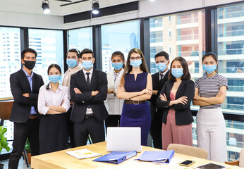 diverse business team Wearing Medical Mask as protection from corona virus. New normal office...