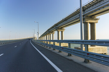 Naklejka premium New asphalt road the road bridge over the Kerch Strait. The railway line runs high on the right