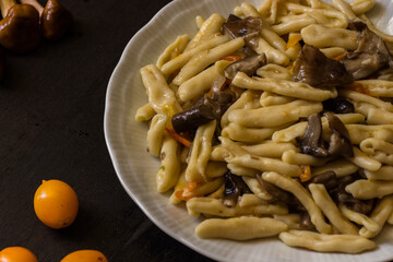 Cavatelli with pioppini mushrooms and yellow cherry tomatoes. Homemade pasta