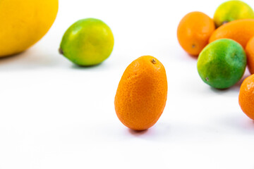 Small citrus cumquat fortunella macro photo on white isolated background