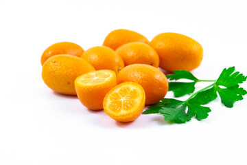Many of kumquat or fortunella photo composition and cutaway exotic and winter fruits on white...