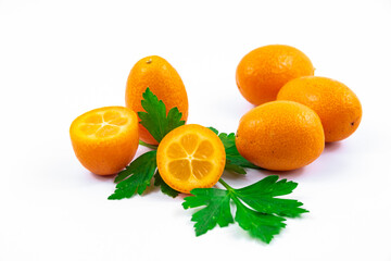 A lot of a small citrus composition of kumquats in greens beautiful photo on white isolated background