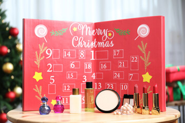 Christmas advent calendar with perfumes, skin care and decorative cosmetics on table