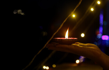 Colorful and sparkling clay diya lamps ready for decorating or illuminating house on diwali, a...