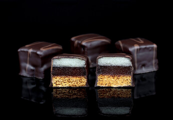 dominoes candy on black acrylic glass with reflection 