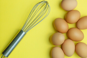 Flat lay composition with chicken eggs on yellow background