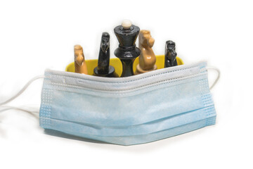 Wooden chess pieces covered with a medicna mask