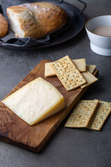  Peace of cheese sliced on a wooden board 