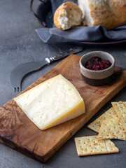  Peace of cheese sliced on a wooden board 