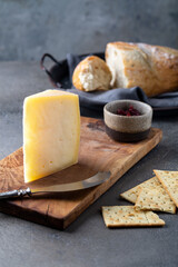  Peace of cheese sliced on a wooden board 