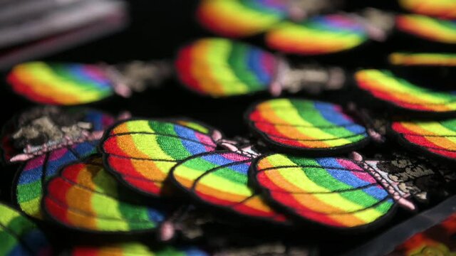 Rainbow flag theme pins are seen displayed on a table during a 2020 Hong Kong LGBT Pride event.
