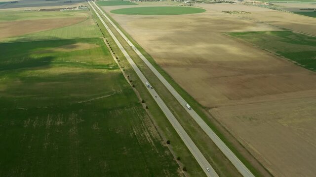 The Great Plains holds one straight highway that leads into the horizon. These trucks and other vehicles won't see anything but a few cows for miles.
