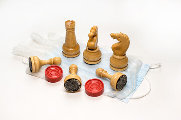 Fototapeta na wymiar wooden chess pieces on the Medecin mask