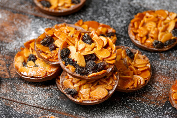 Christmas Chocolate Florentines cookies with almond and raisins with decoration, gifts, green tree branch on wooden rustic table
