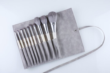 set of makeup brushes in a suede case