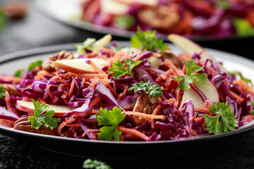 Red Cabbage salad with carrots, apples and pecan nuts. Healthy vegan food