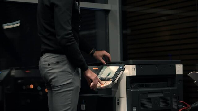 Businessman Working In Office And Preparing Documents For Signature.Man Using Printer Or Scanner In Office.Businessman Printing Document On Workplace.Man Finger Press Buttons On Multifunctional Copier