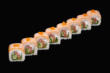 sushi roll with medium salmon, cold smoked salmon, Feta cheese, cucumber, lettuce, red caviar isolated on black