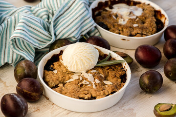 Freshly baked pastries with fresh plums and garnished with ice cream. Dessert for the morning