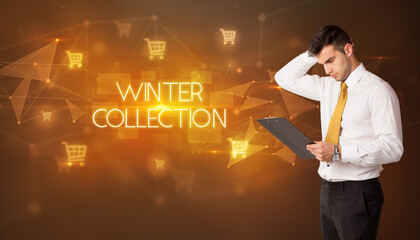 Businessman with shopping cart icons and WINTER COLLECTION inscription, online shopping concept