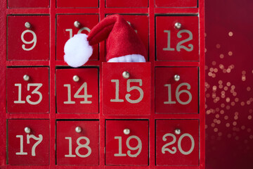 Red wooden Advent calendar with surprise for Christmas