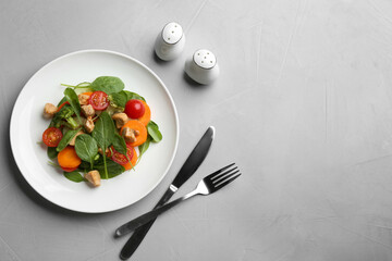 Delicious fresh chicken salad served on grey table, flat lay. Space for text
