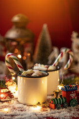 Hot chocolates surrounded with christmas decorations