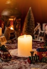 Candle surrounded with christmas decorations. Christmas country