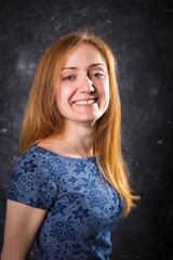 Naklejka premium Pretty young woman looking in camera studio portrait