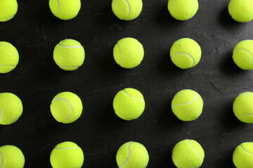Tennis balls on black background, flat lay. Sports equipment