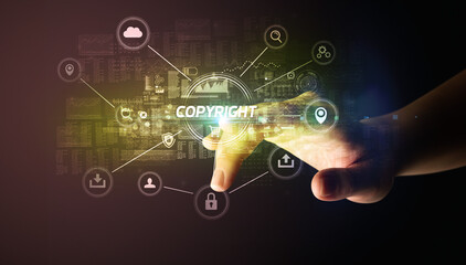 Hand touching COPYRIGHT inscription, Cybersecurity concept