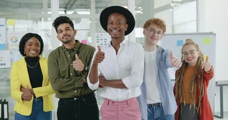 Close up of likable in high spirits successful young professional trendy international group of office workers which standing in front of camera and showing gesture "like"