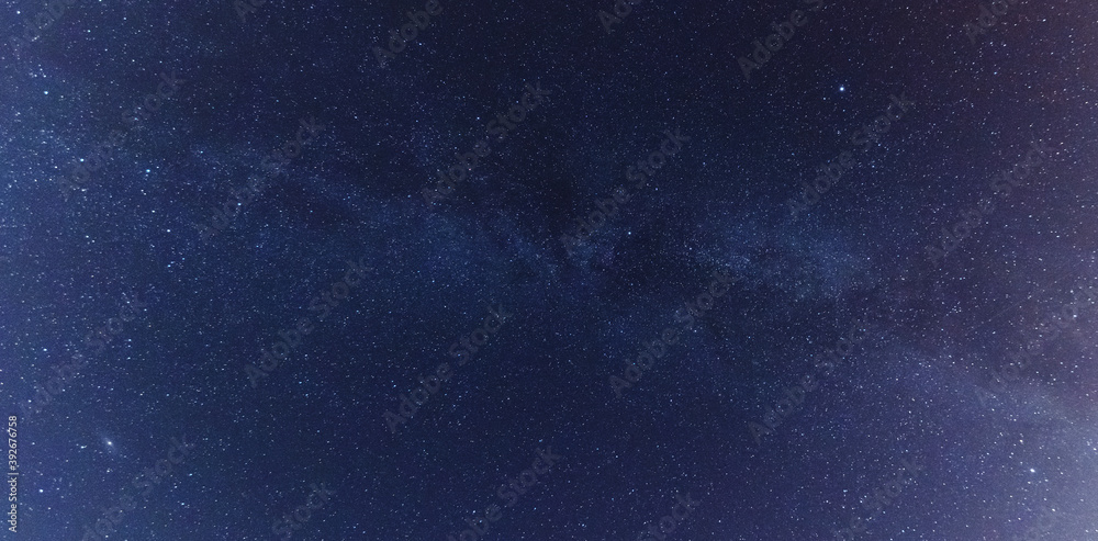 Wall mural a magical starry night on the river by the milky way and a comet in the sky
