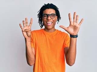 Young african american man wearing casual clothes and glasses showing and pointing up with fingers...