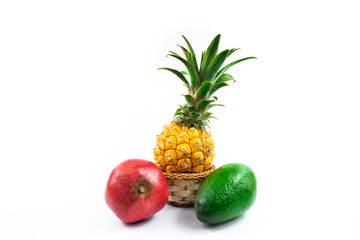 Large exotic fruits pineapple avocado and pomegranate assorted beautiful composition on white isolated background