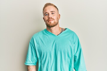 Fototapeta premium Young caucasian man wearing casual clothes relaxed with serious expression on face. simple and natural looking at the camera.