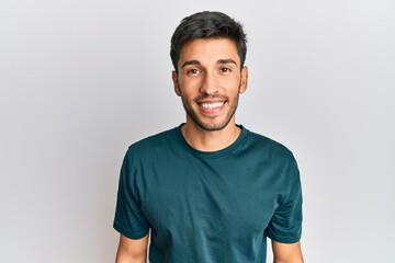 Young handsome man wearing casual clothes with a happy and cool smile on face. lucky person.