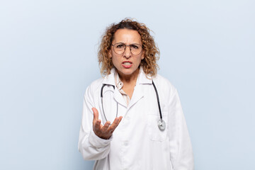 hispanic middle age woman looking angry, annoyed and frustrated screaming wtf or what’s wrong...