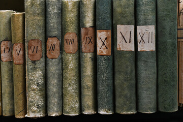 Old books with Roman numerals in the library