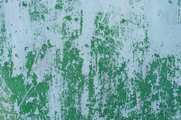 Painted in green old cracked metal rusted background. Metal texture. Erosion metal. Scratched and dirty texture on outdoor metal wall.