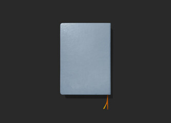 blue closed notepad with bookmark on black background, template, place for text