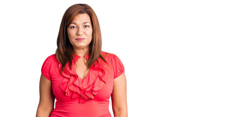Middle age latin woman wearing casual clothes with serious expression on face. simple and natural...