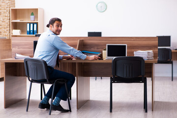 Young male employee in industrial espionage concept