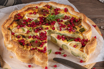 Homemade quiche with vegetables, brussels spouts, goat cheese and pomegranate. Vegetarian food. French cuisine