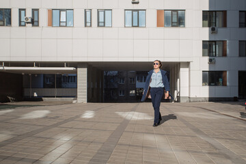 business woman in the coat walking in the autumn city