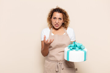 hispanic middle age woman looking angry, annoyed and frustrated screaming wtf or what’s wrong...