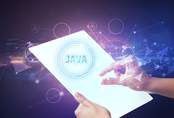 Hand holdig futuristic tablet with JAVA inscription, modern technology concept