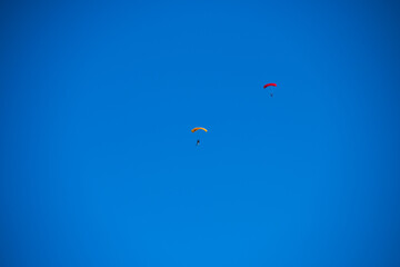 Parachutist on the background of blue sky
