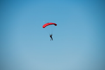 Fototapeta na wymiar Parachutist on the background of blue sky