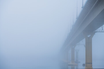 Bridge over the river in heavy fog